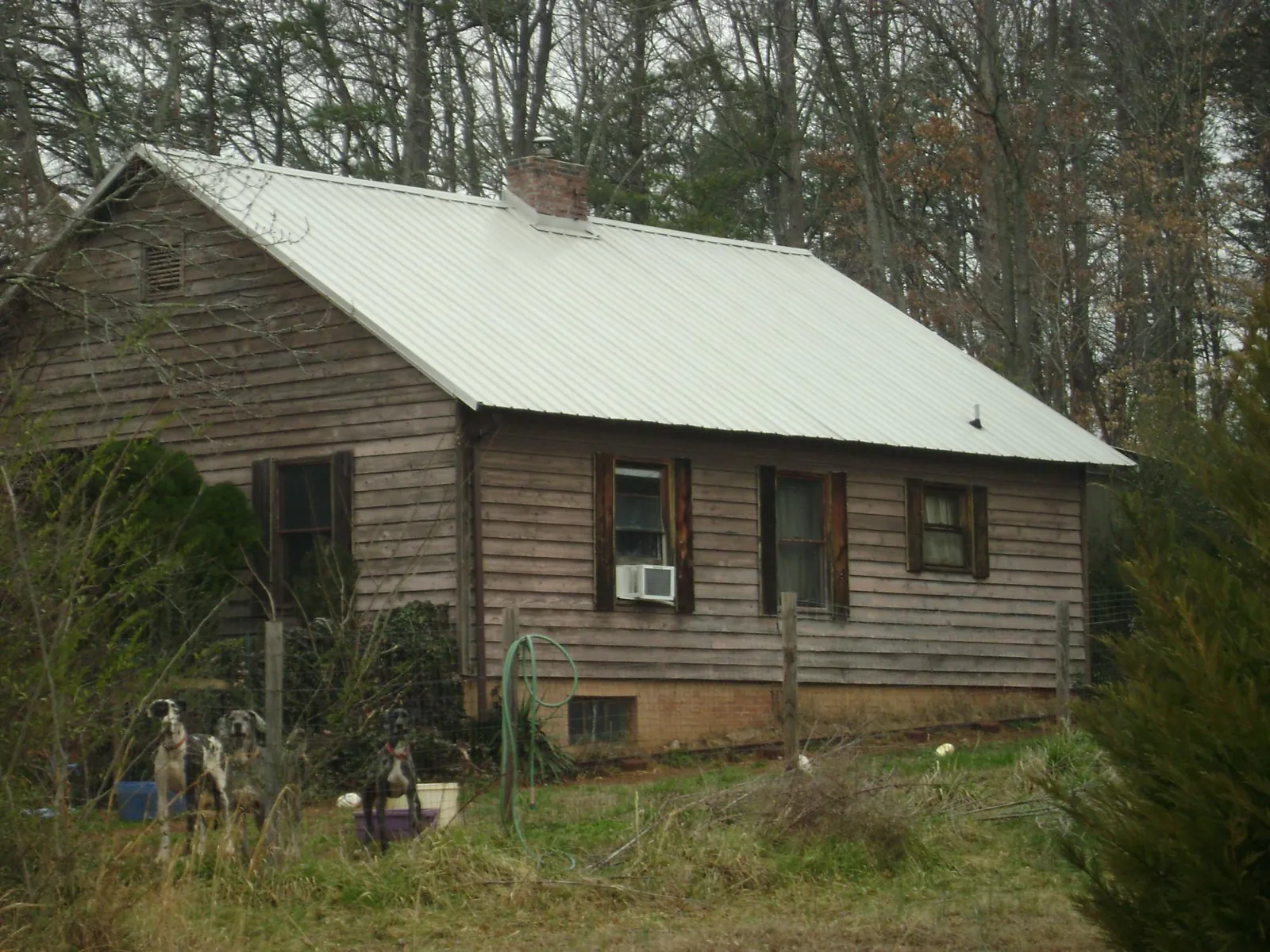 White metal roof on an old wood sided farmhouse, from a Metal Roof Installation job in Funston